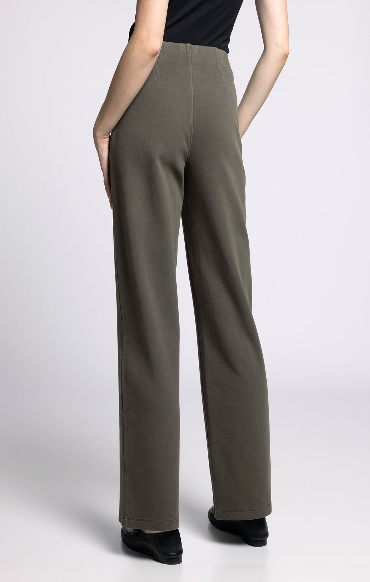 Green wide-leg pants worn by a person on a white background