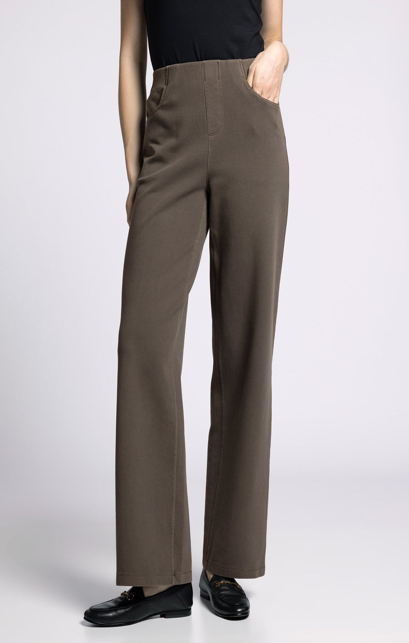 Brown pants worn by a person on a white background