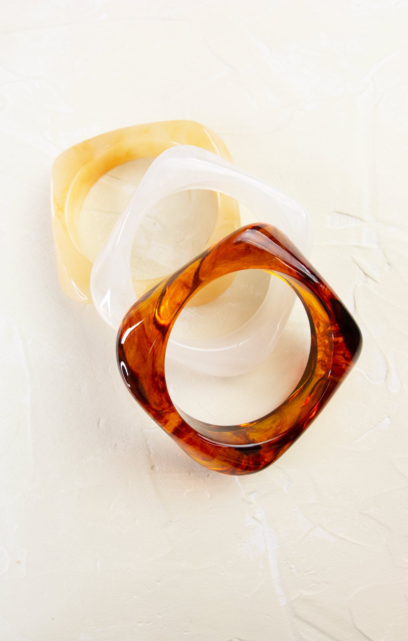 Two tortoiseshell rings on a white background