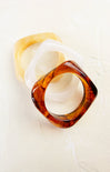 Two tortoiseshell rings on a white background