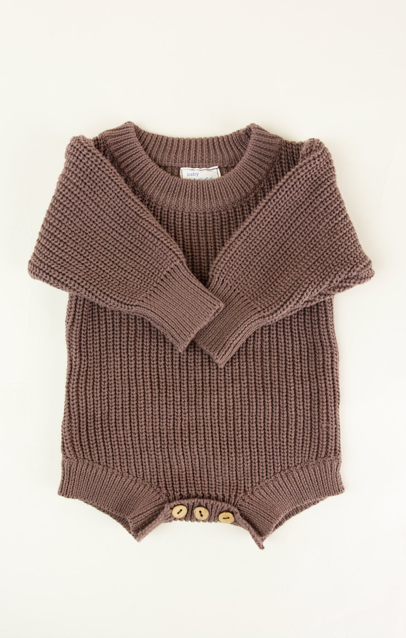 Brown knitted romper with a collar on a white background