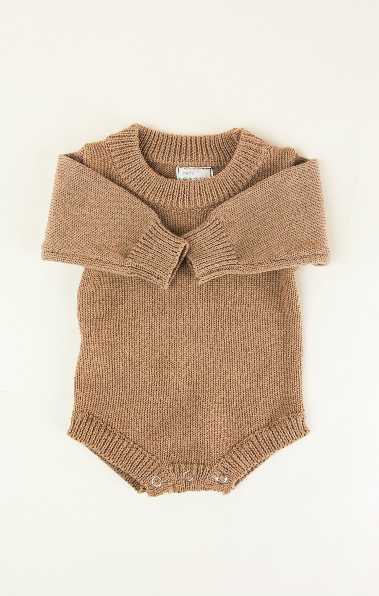 Brown knitted romper with collar on a white background