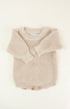 Knitted beige baby romper on a white background
