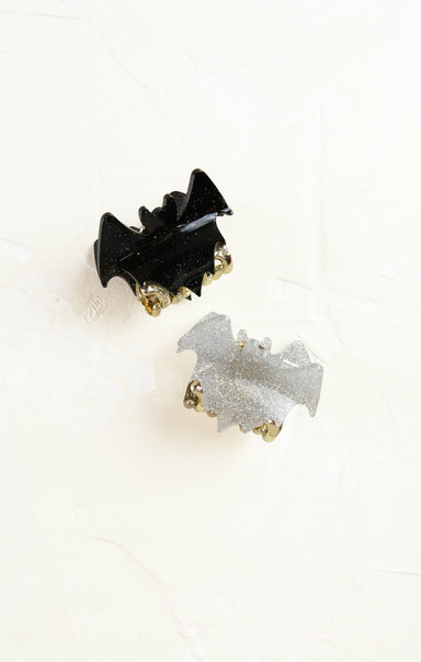 Black and silver bat-shaped earrings on a white background