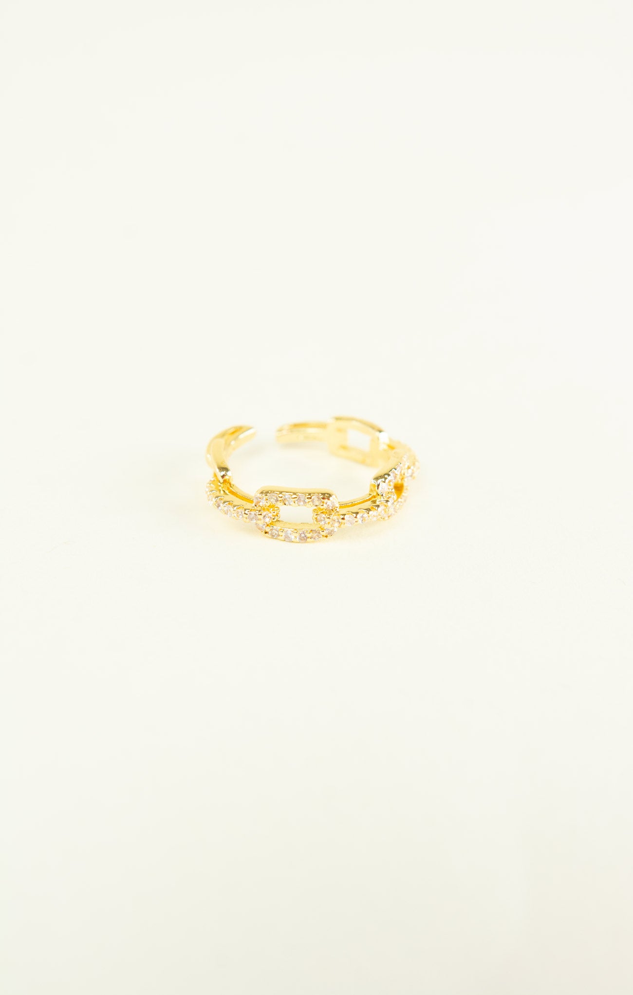 Gold ring on a light beige background