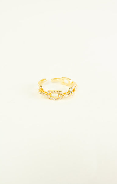 Gold ring on a light beige background