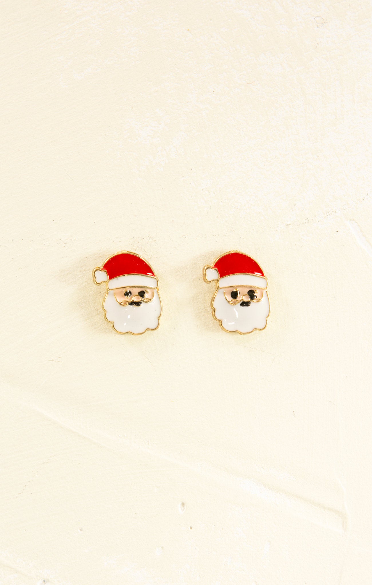 Santa Claus earrings on a beige background