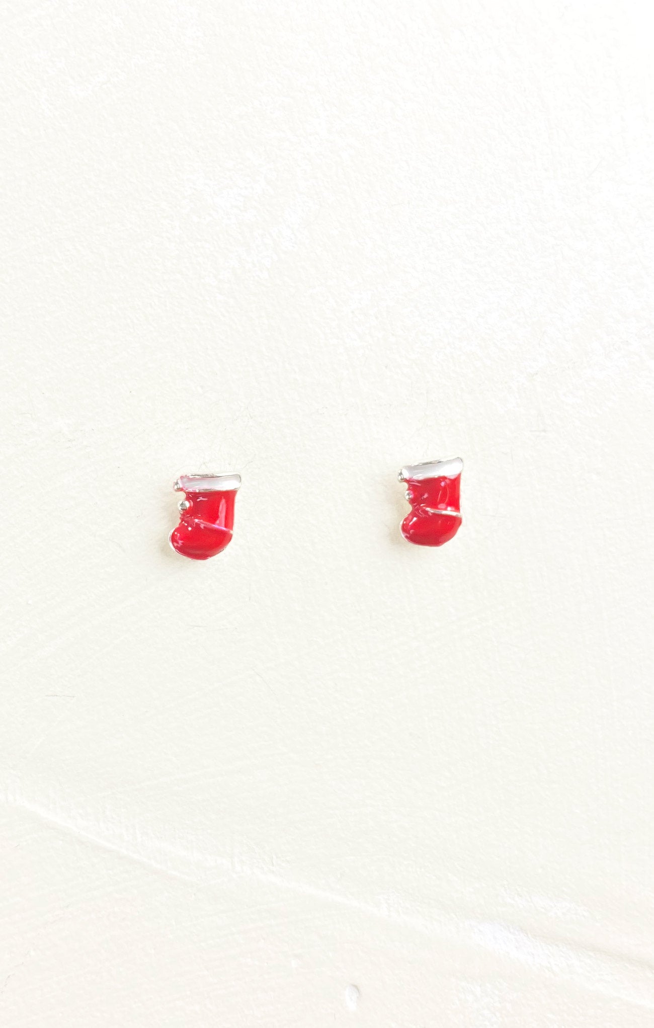 Red boxing glove earrings on a white background