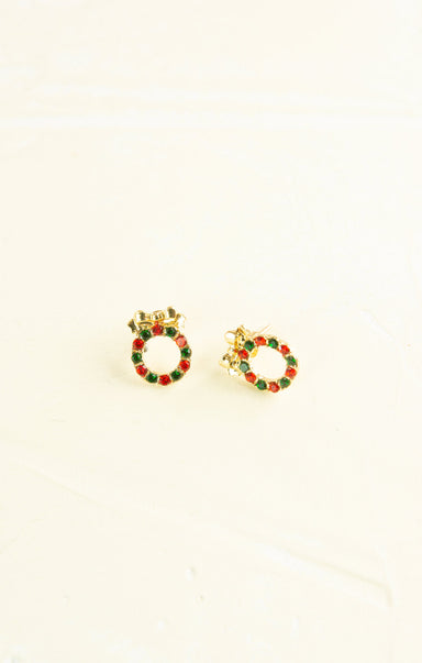 Gold hoop earrings with red and green accents on a white background