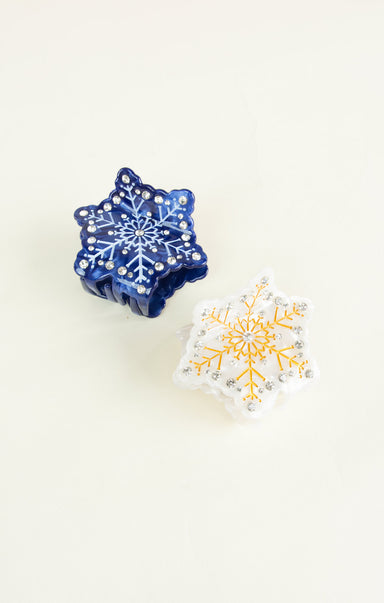 Two decorative snowflake ornaments on a white background