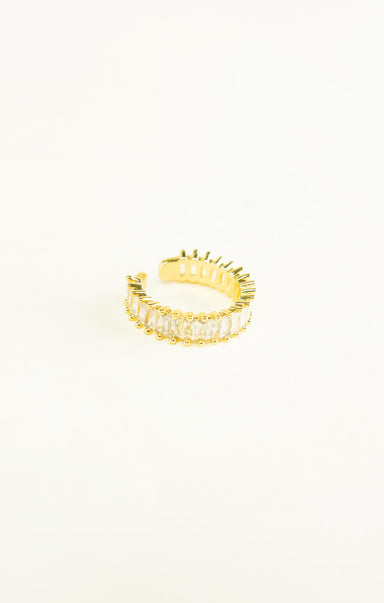 Gold ring with a textured design on a white background