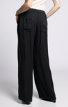 Black wide-leg pants worn by a person on a light gray background
