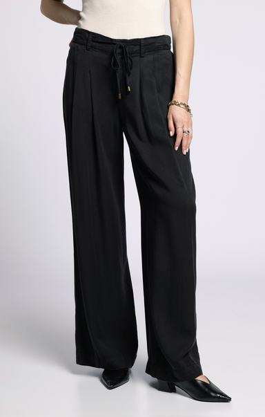 Black wide-leg pants worn by a person on a white background