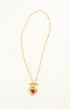Gold necklace with a heart-shaped pendant on a white background
