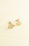 Pair of gold Christmas tree-shaped earrings on a beige background