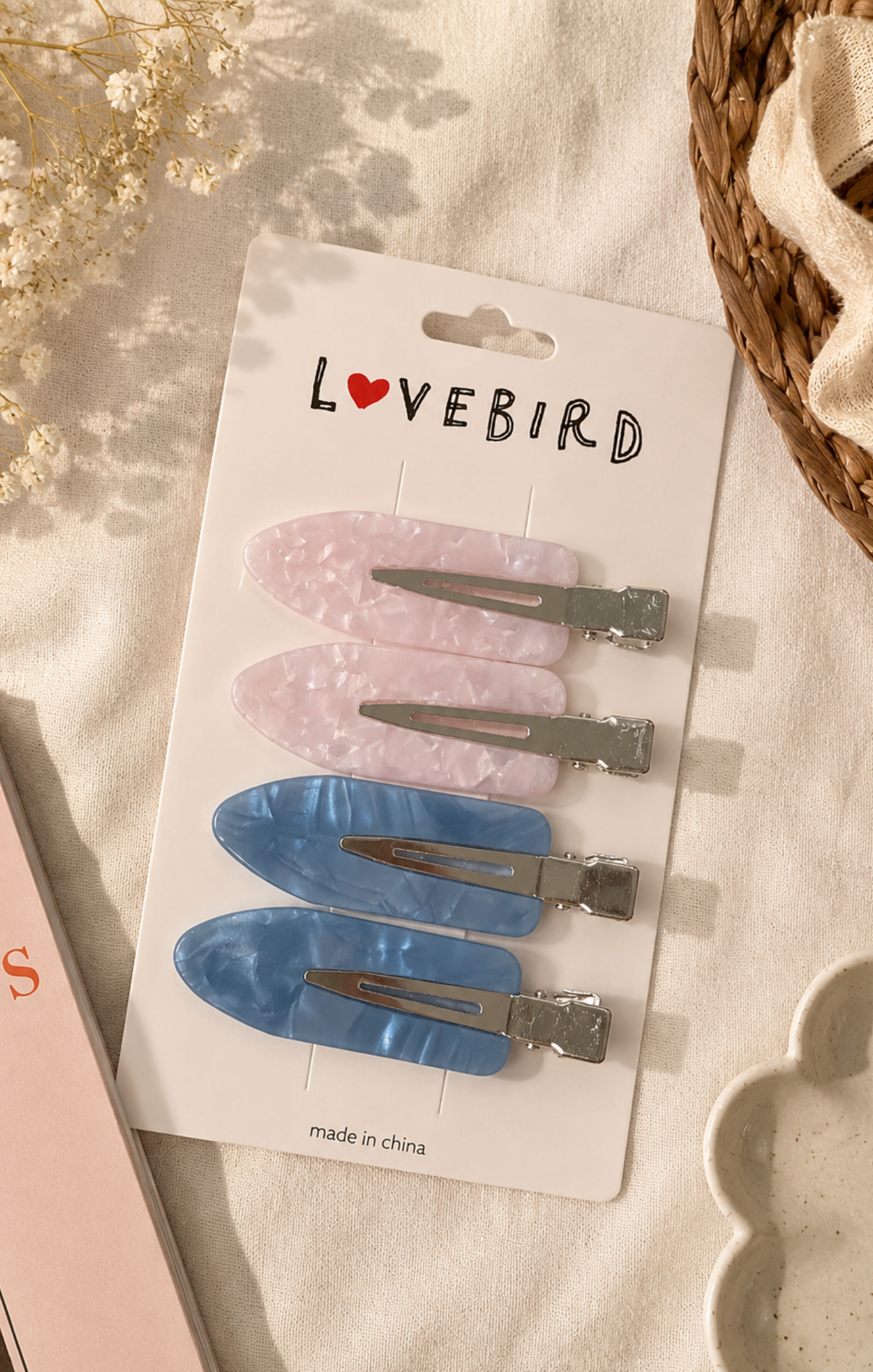 Set of hair clips on a 'Lovebird' branded card with a soft background