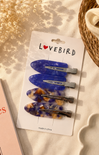 Set of hair clips on a 'Lovebird' branded card with a soft background