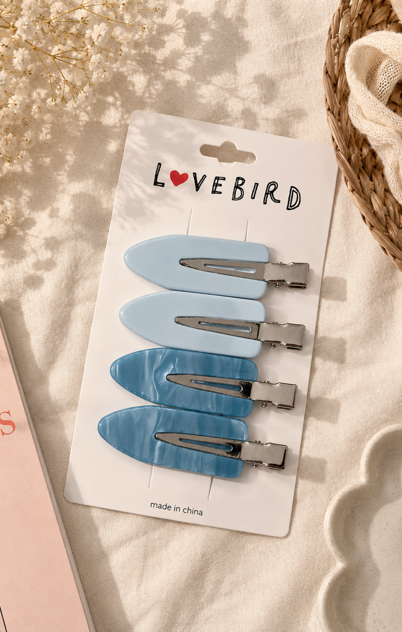 Set of blue hair clips on a 'Lovebird' branded card with a soft background.