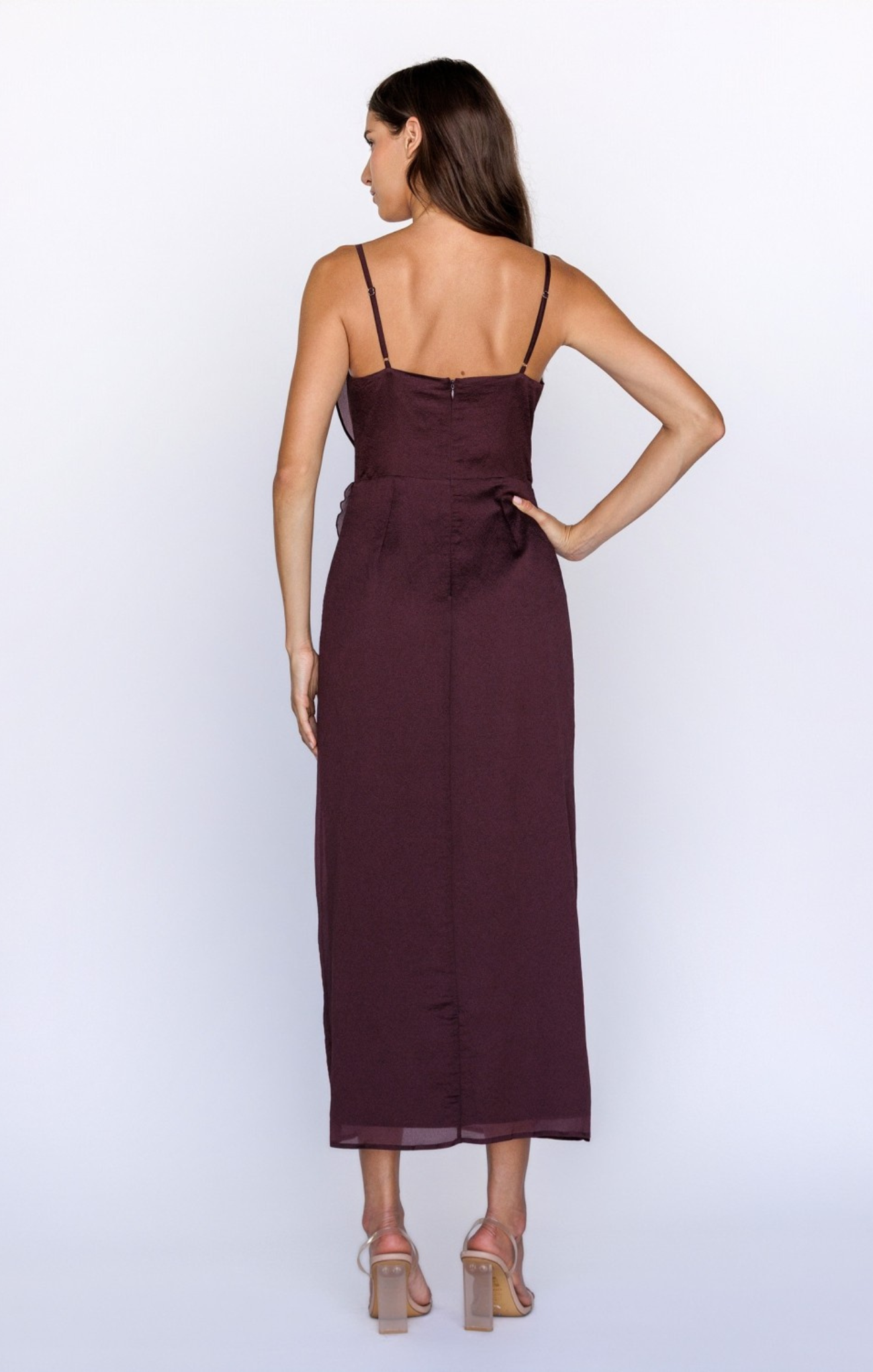 Woman wearing a burgundy dress on a white background