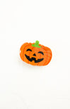 Pumpkin-shaped object with a smiling face on a white background