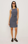 Woman wearing a navy and white striped dress on a plain background