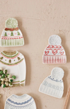Decorative wall art of knitted hats on a textured beige background