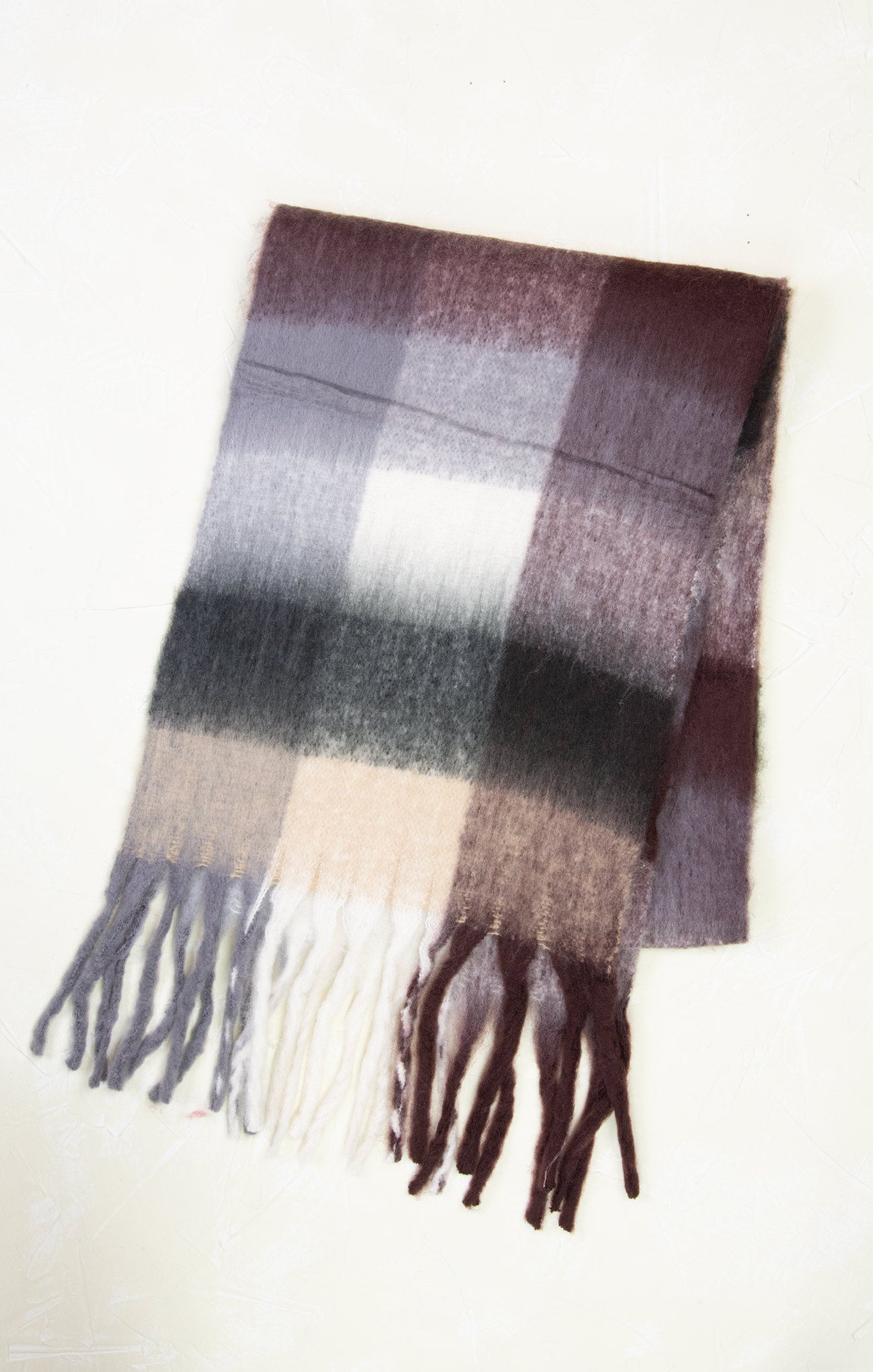Plaid scarf with fringes on a white background