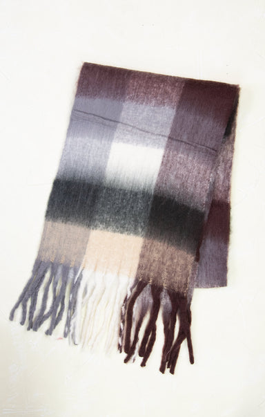 Plaid scarf with fringes on a white background