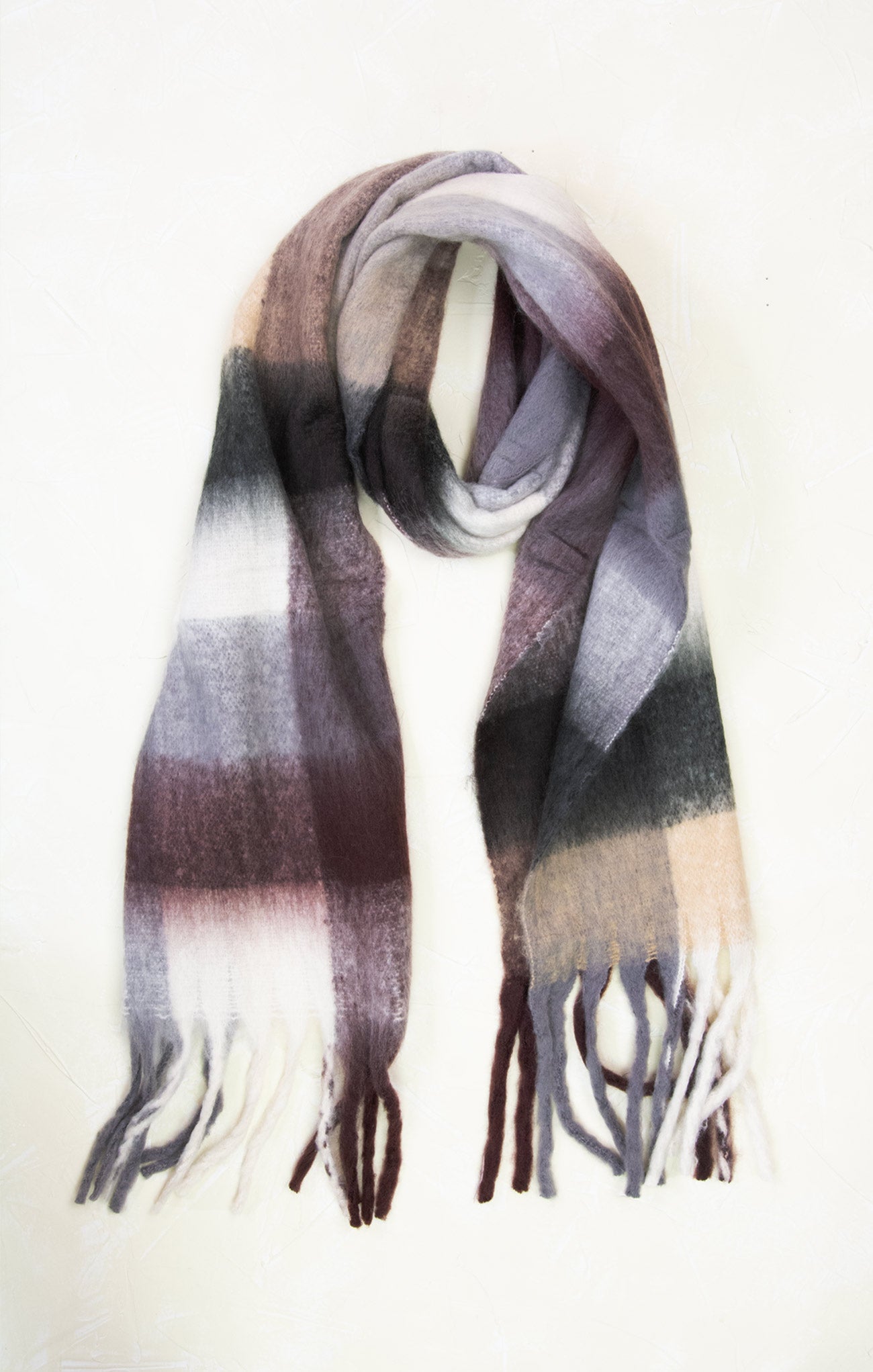 Plaid scarf with fringe on a mannequin against a white background