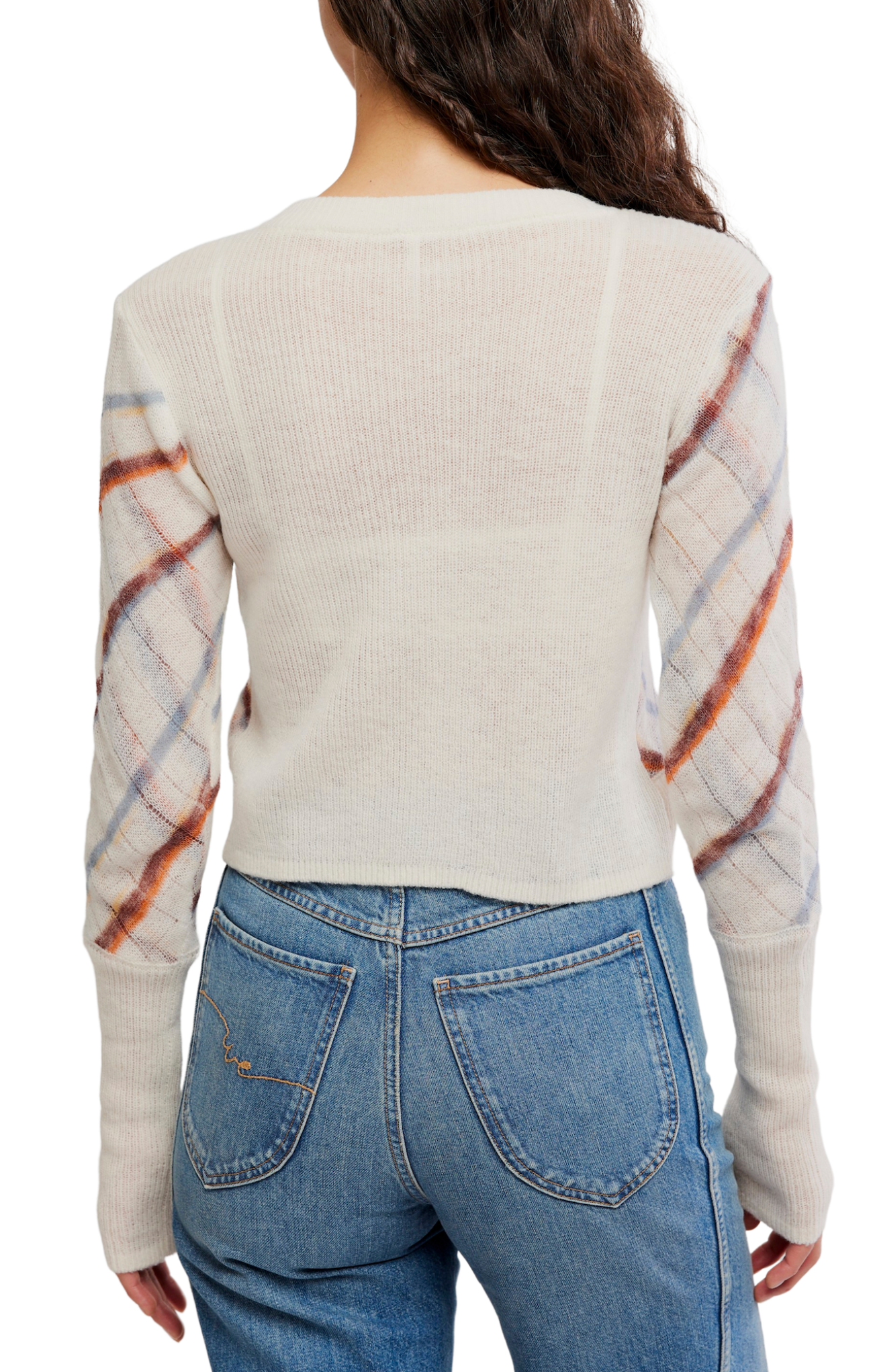 A woman shown from the back wearing a cream-colored knit sweater with patterned sleeves in orange, blue, and white, paired with blue jeans against a white background.