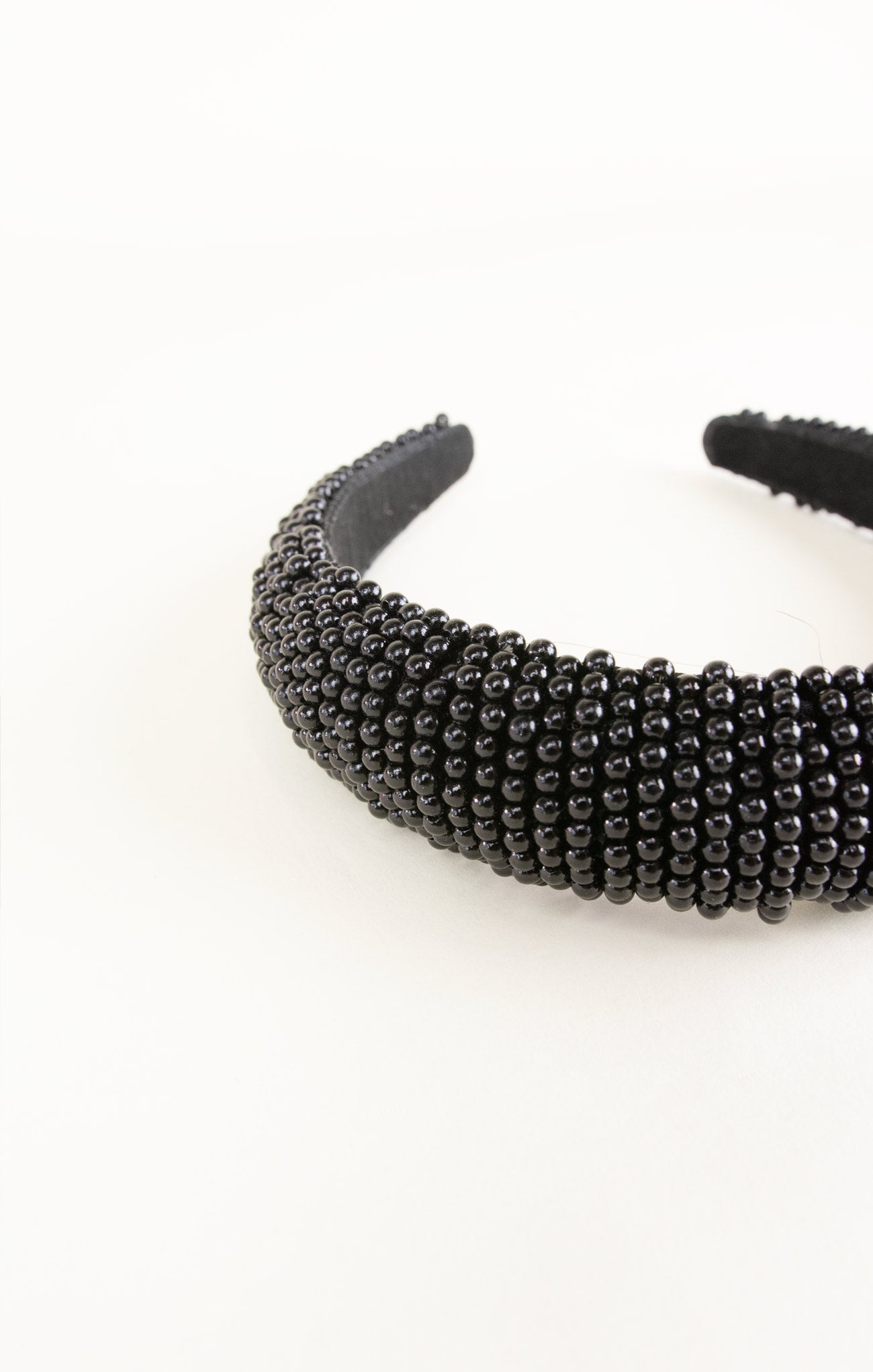Black beaded headband on a white background