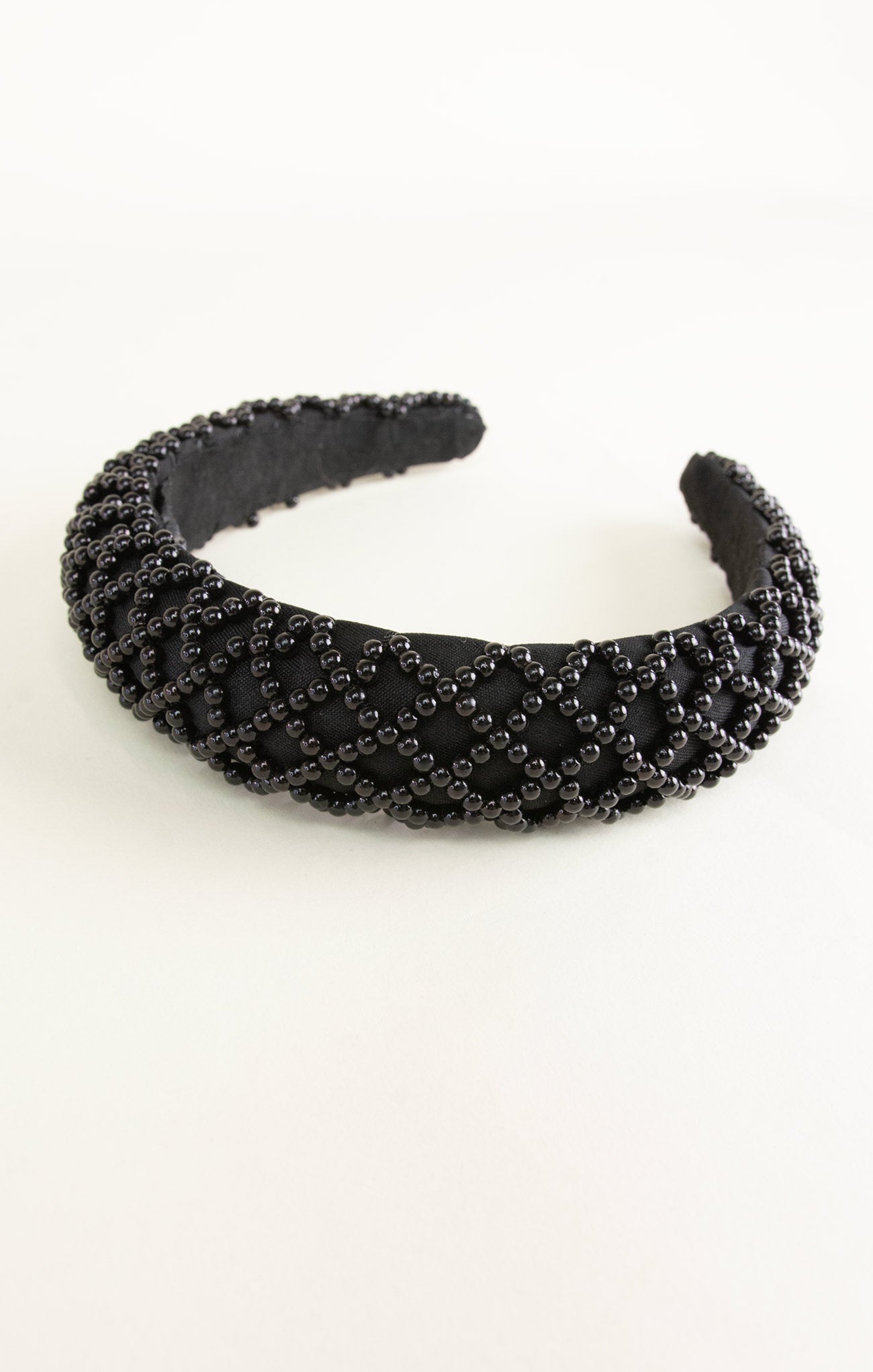 Black beaded headband on a white background