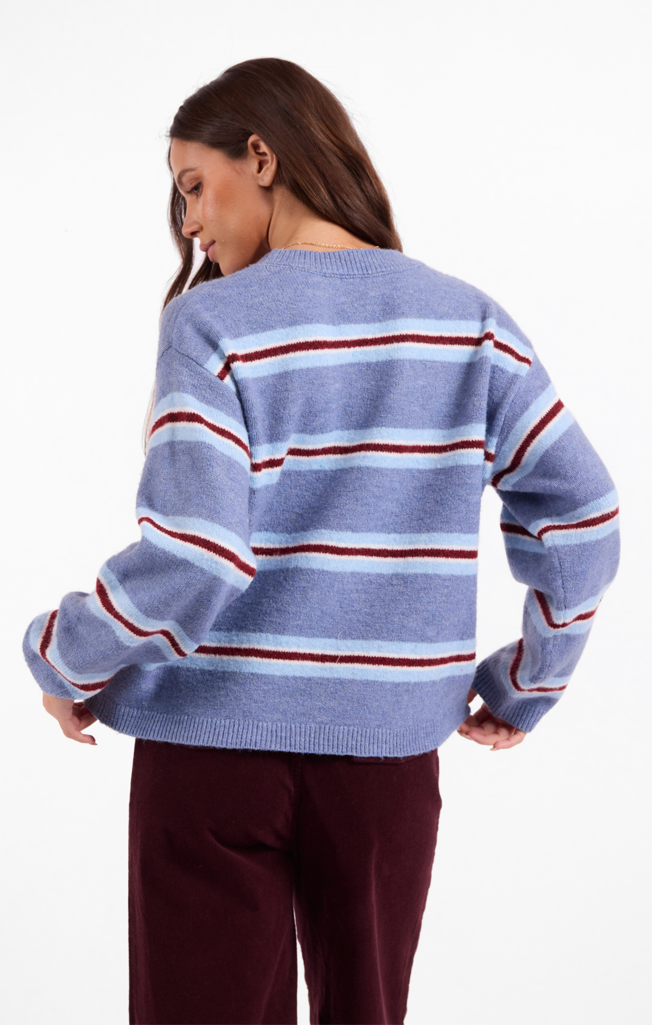Woman wearing a blue and red striped sweater on a white background