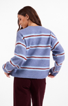 Woman wearing a blue and red striped sweater on a white background