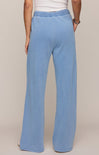 Light blue pants worn by a person on a beige background
