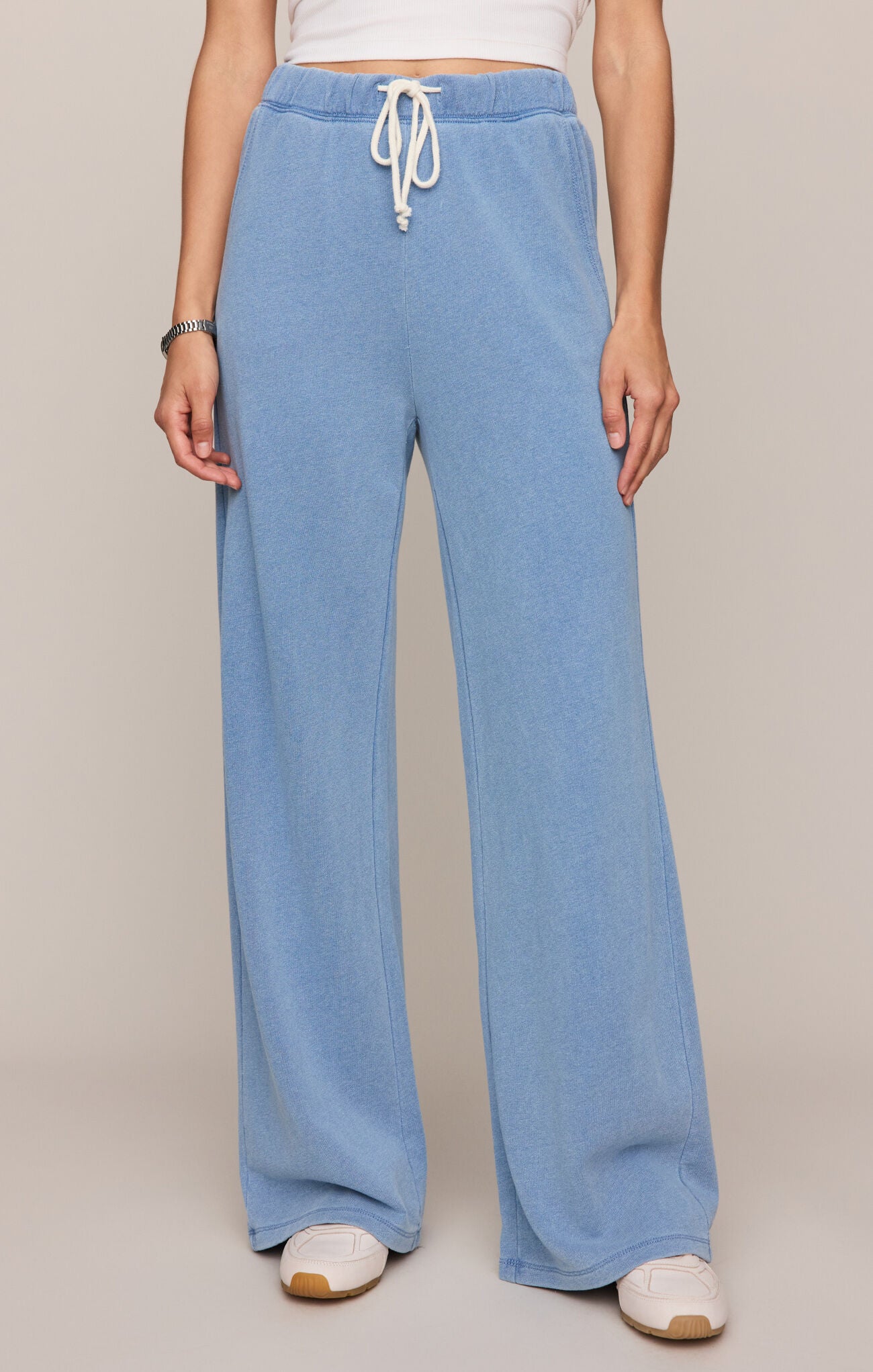 Light blue wide-leg pants with a drawstring waist on a plain background