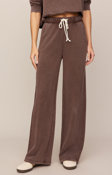 Brown pants with a drawstring waist on a plain background