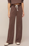 Brown pants with a drawstring waist on a plain background
