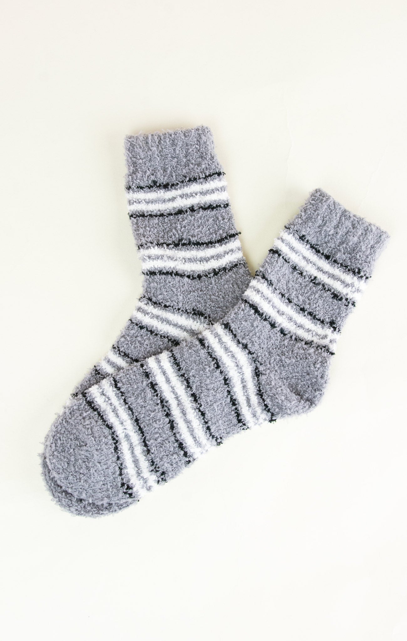 Pair of gray socks with white stripes on a white background