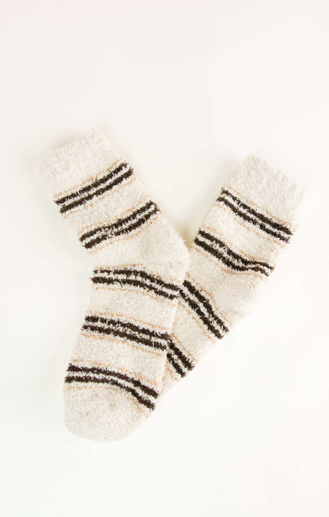 Pair of beige socks with black stripes on a white background