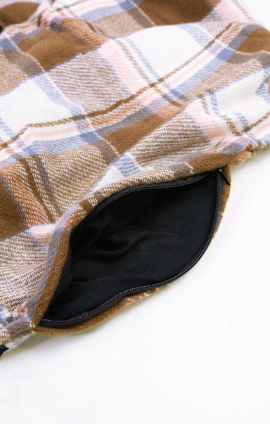Plaid patterned fabric with a zipper on a white background