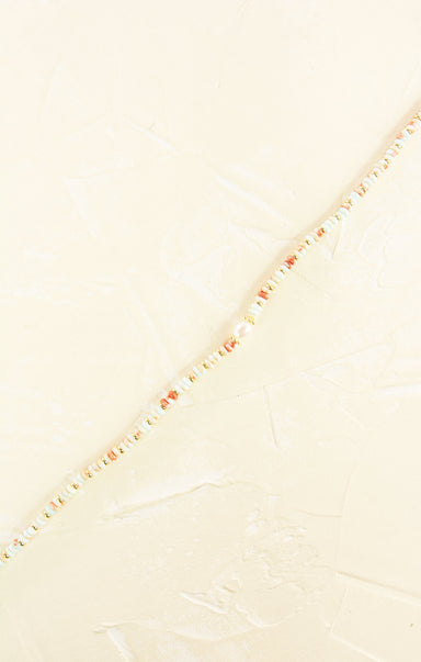 Close-up of a textured fabric with a subtle pattern on a light beige background