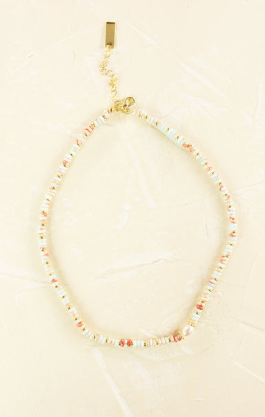 Necklace with small beads on a beige background