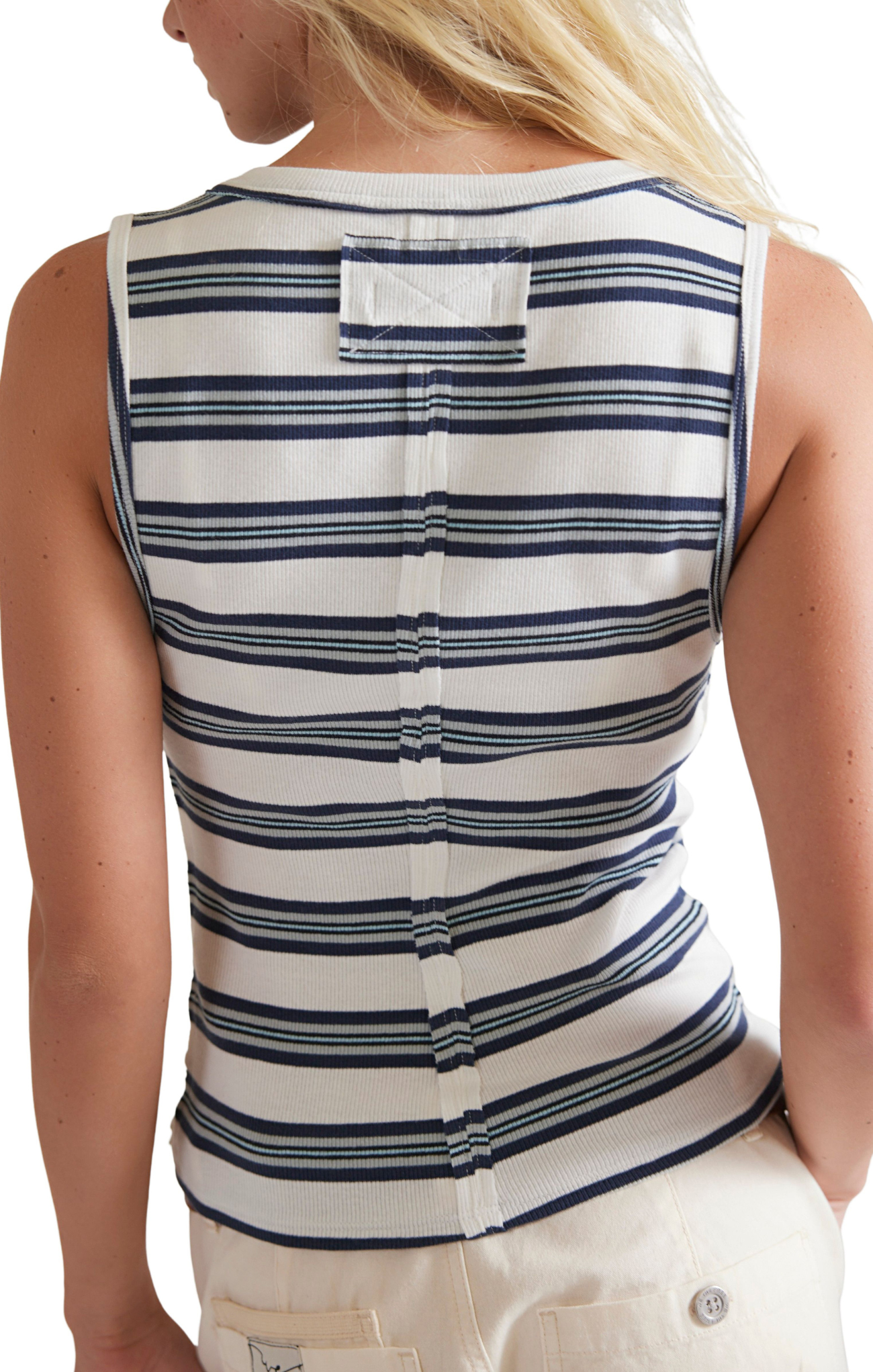 Close-up of a person wearing a white and blue striped shirt with a blurred background