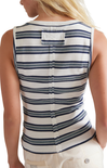 Close-up of a person wearing a white and blue striped shirt with a blurred background