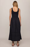 Black sleeveless dress worn by a person on a plain background