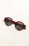 Red sunglasses with dark lenses on a white background