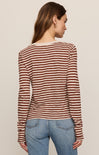 Person wearing a striped long-sleeve shirt and jeans on a plain background