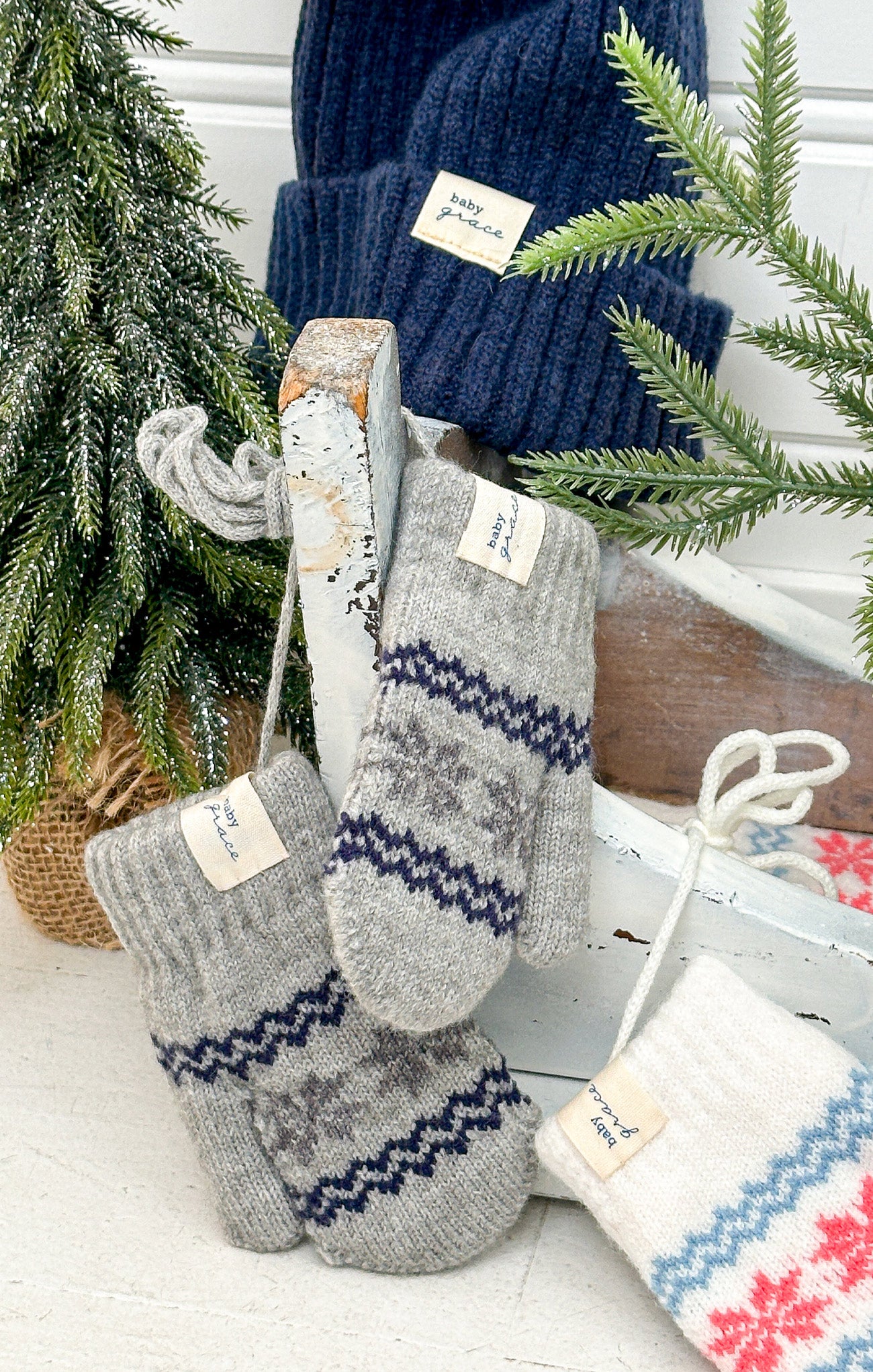 Knitted socks with a pattern in front of a Christmas tree