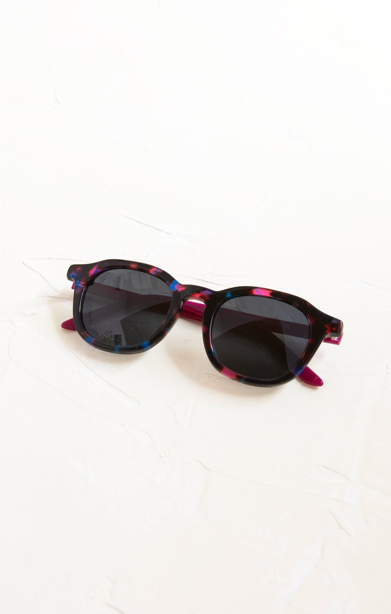 Sunglasses with a colorful frame on a white background